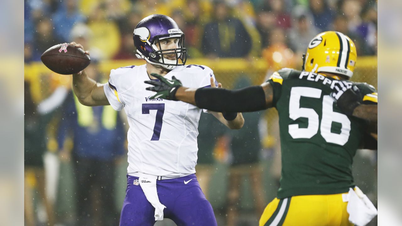 Green Bay Packers' Nick Perry (53) and A.J. Hawk (50) sack Minnesota  Vikings quarterback Christian Ponder (7) during the second half of an NFL  football game Thursday, Oct. 2, 2014, in Green