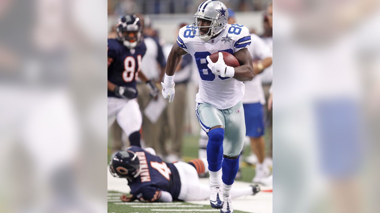 Dallas Cowboys Dez Bryant, jumping left, celebrates his 62-yard punt return  for a touchdown against the Chicago Bears during the first half of their  NFL game September 19, 2010 in Arlington, Texas.