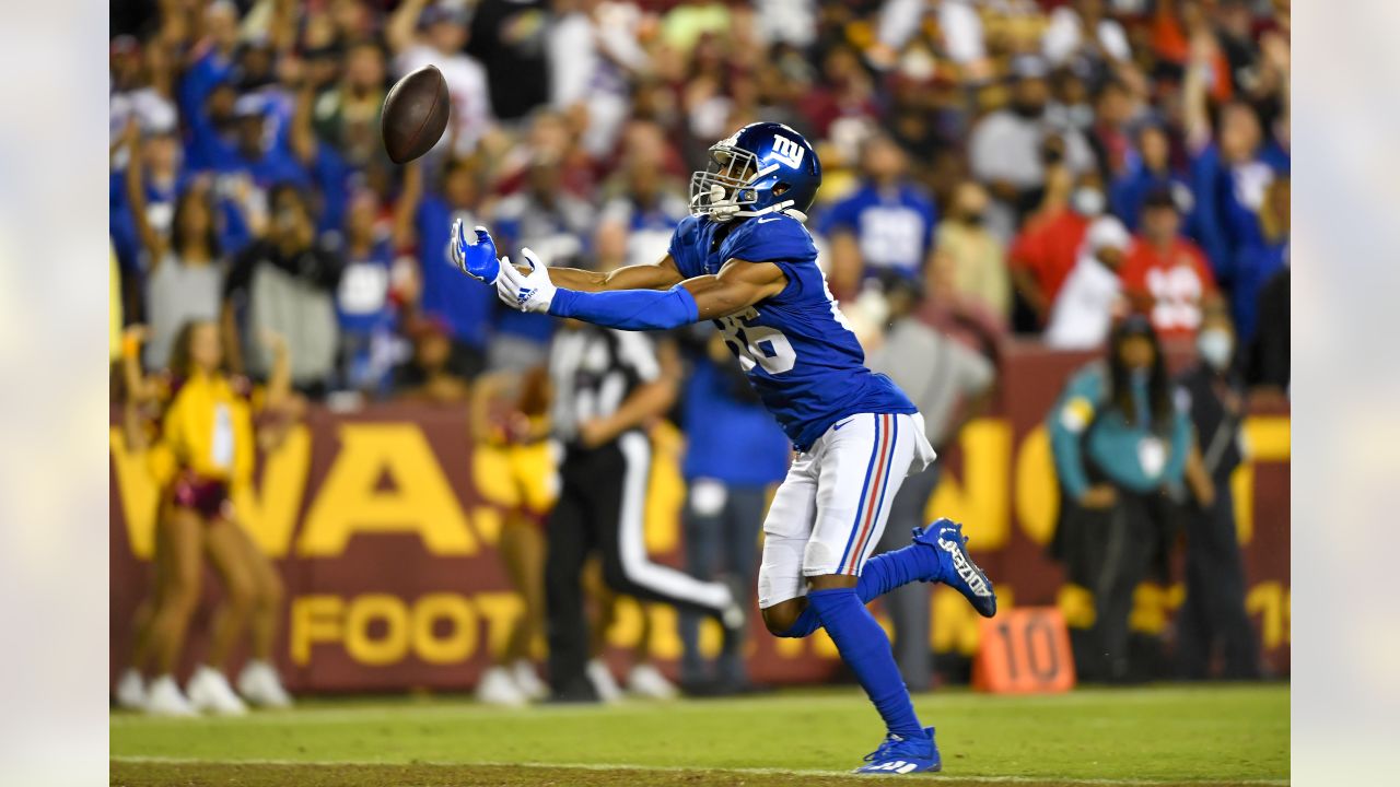 EAST RUTHERFORD, NJ - AUGUST 28: New York Jets wide receiver Corey Davis  (84) is tackled by New York Giants cornerback Aaron Robinson (33) during  the National Football League preseason game between