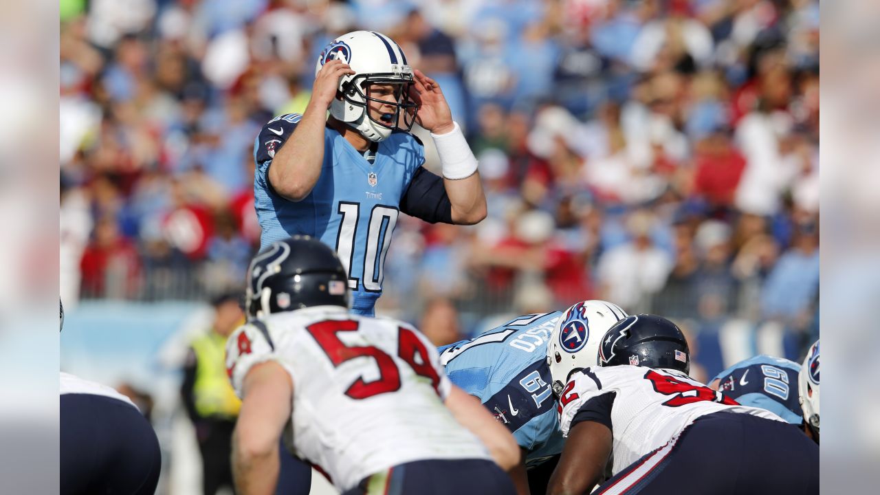 Tennessee Titans quarterback Jake Locker (10) scrambles against