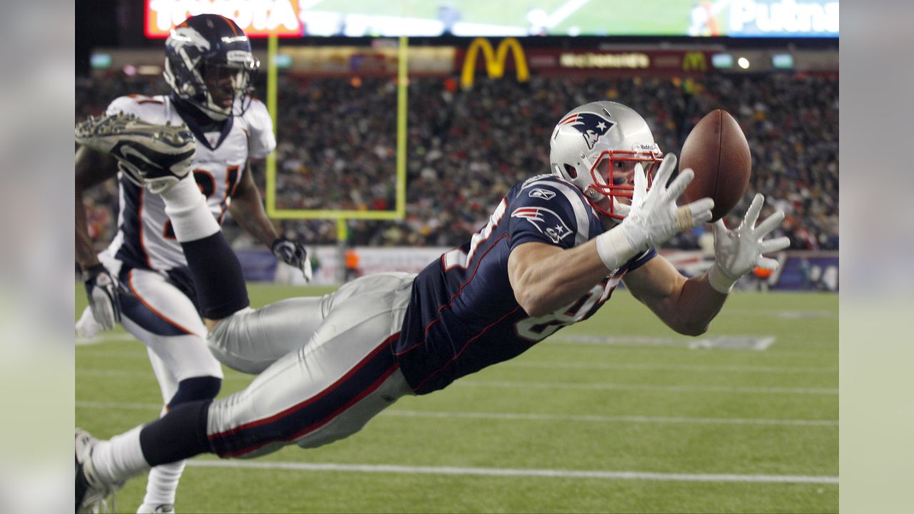 New England Patriots rookie tight end Rob Gronkowski grabs his first NFL  touchdown catch, next to Cincinnati Bengals linebacker Dhani Jones, during  the second half of New England's 38-24 win in an