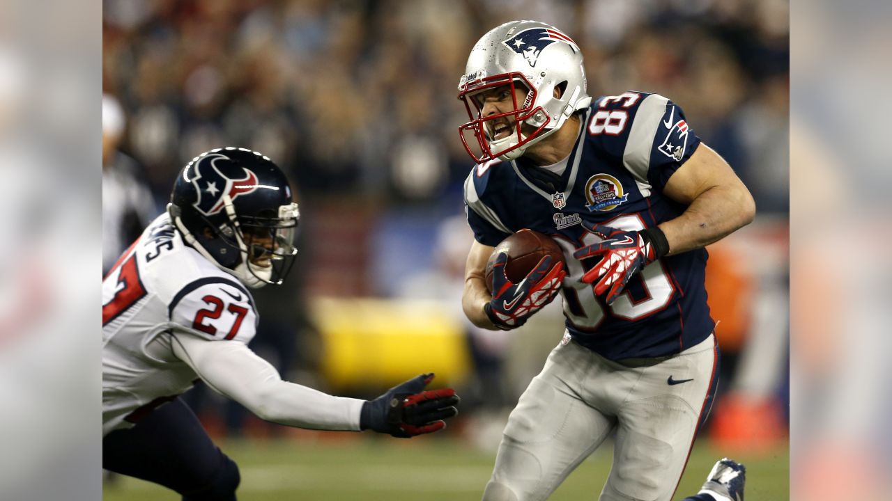 New England Patriots wide receiver Donte' Stallworth (19) runs past Houston  Texans cornerback Brandon Harris (26) and safety Quintin Demps (27) on a  63-yard touchdown reception in the third quarter at Gillette