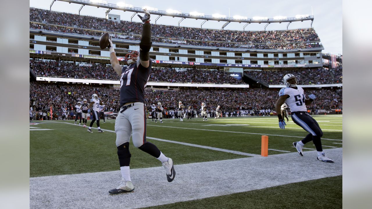 New England Patriots tight end Rob Gronkowski (87) runs from Cincinnati  Bengals defenders after catching a pass during the second half of an NFL  football game, Sunday, Oct. 16, 2016, in Foxborough