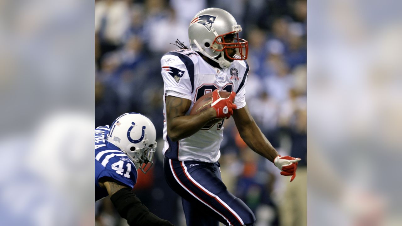 Indianapolis Colts wide receiver Reggie Wayne (87) is hit by New England  Patriots cornerback Jonathan Wilhite (