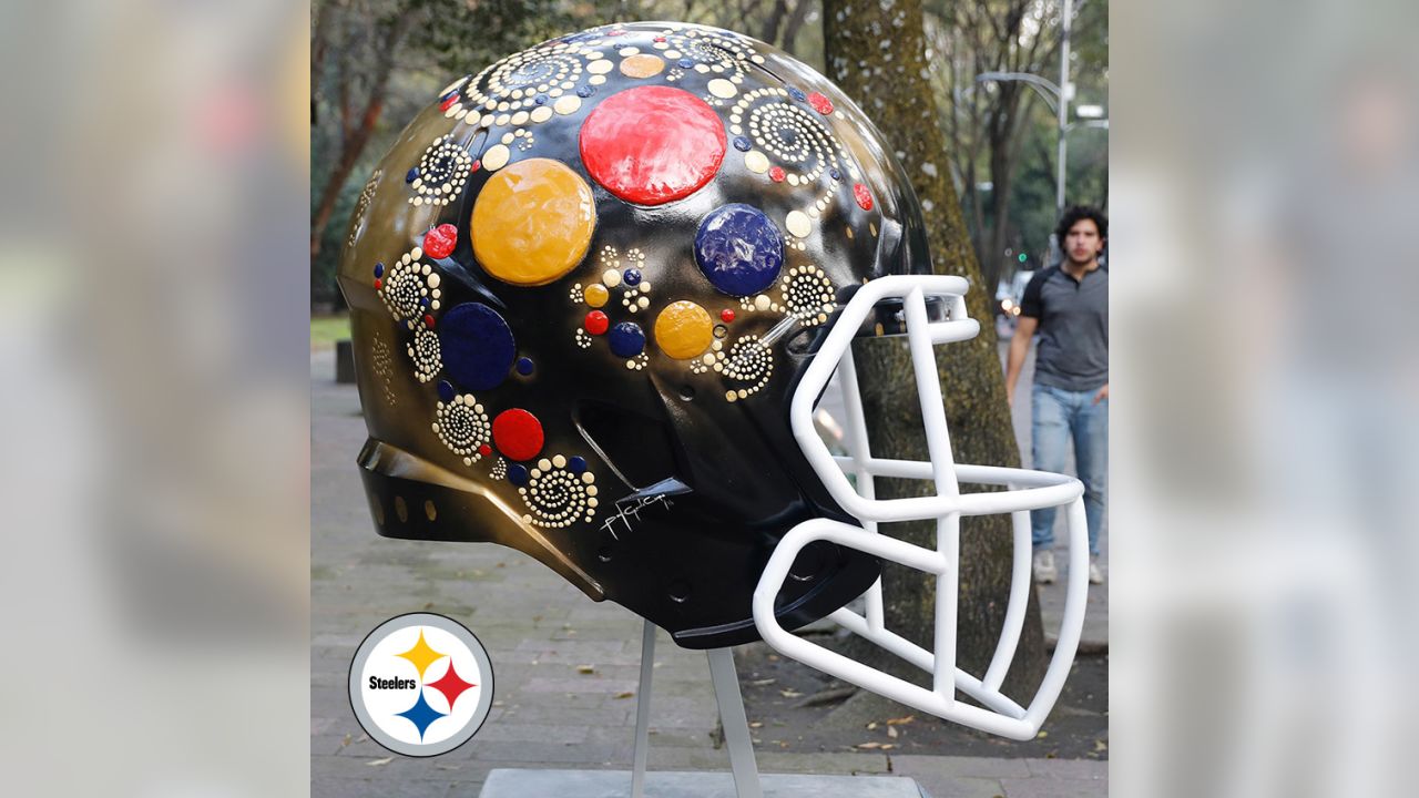 Artists take on all 32 NFL team helmets