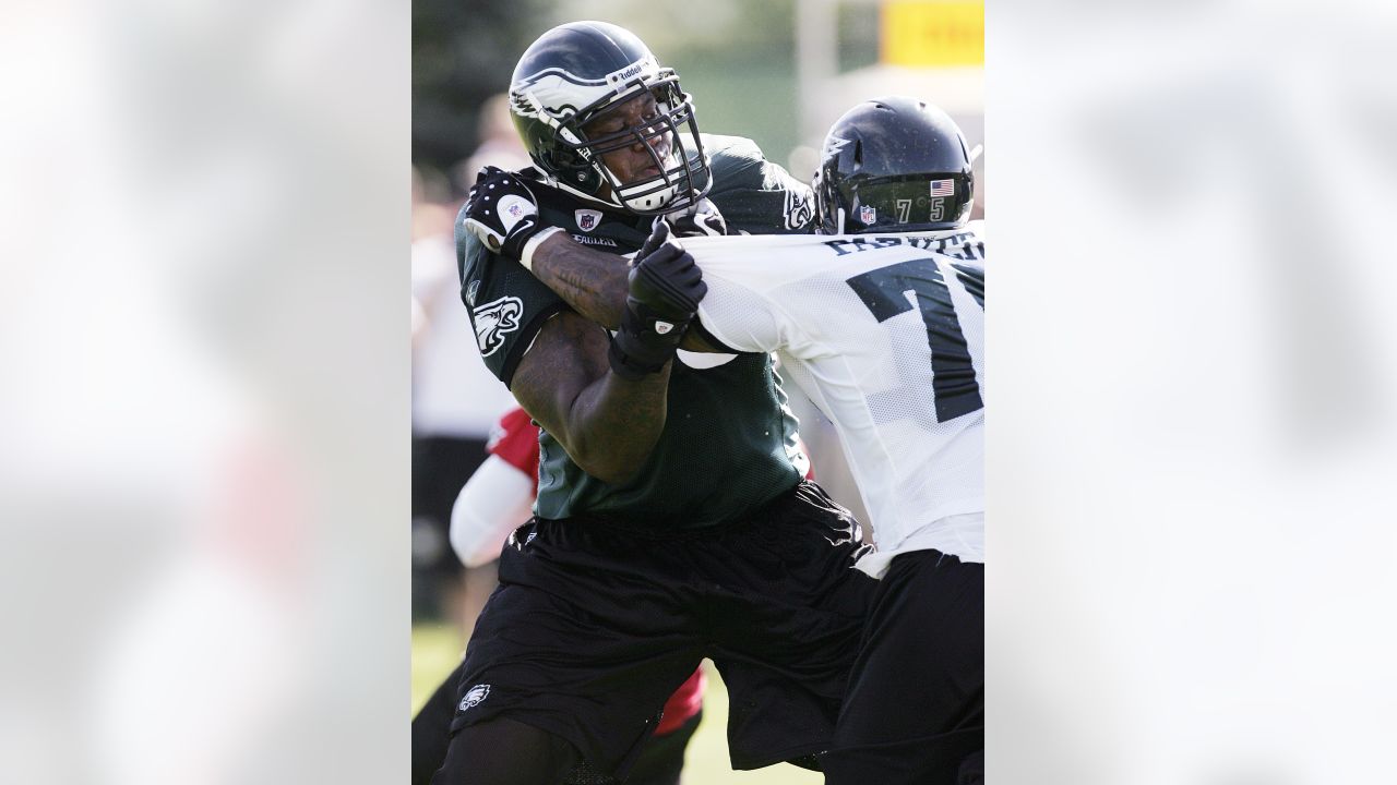 Philadelphia Eagles quarterback Michael Vick's daughter Jada Vick, 6, left,  tries to take her father's helmet off her sister London Vick, 3, after an  NFL football training camp practice at Lehigh University