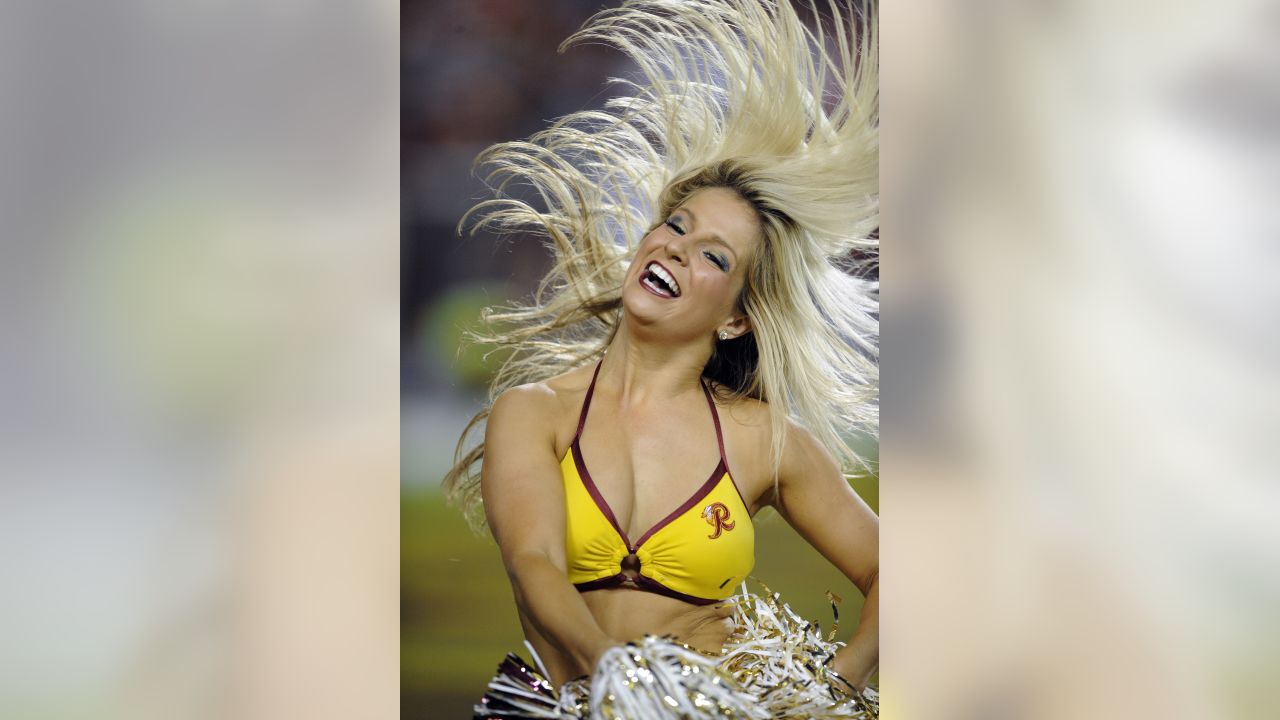 A Washington Commanders cheerleader performs during the first half of an  NFL preseason football game between the Washington Commanders and the  Baltimore Ravens, Monday, Aug. 21, 2023, in Landover, Md. The Commanders