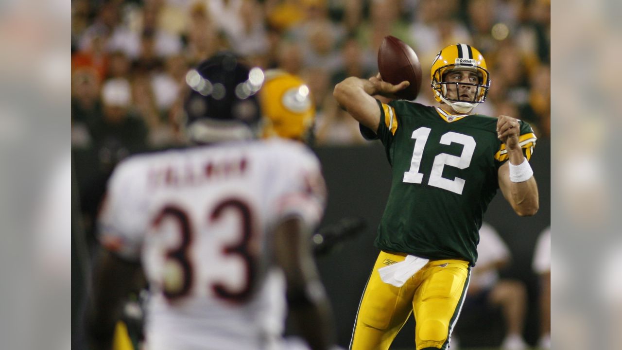 Cole Brennan of Manitowoc wears an old Brett Favre jersey with Green Bay  Packers quarterback Aaron Rodgers number taped over as he plays catch in  the parking lot of Lambeau Field before