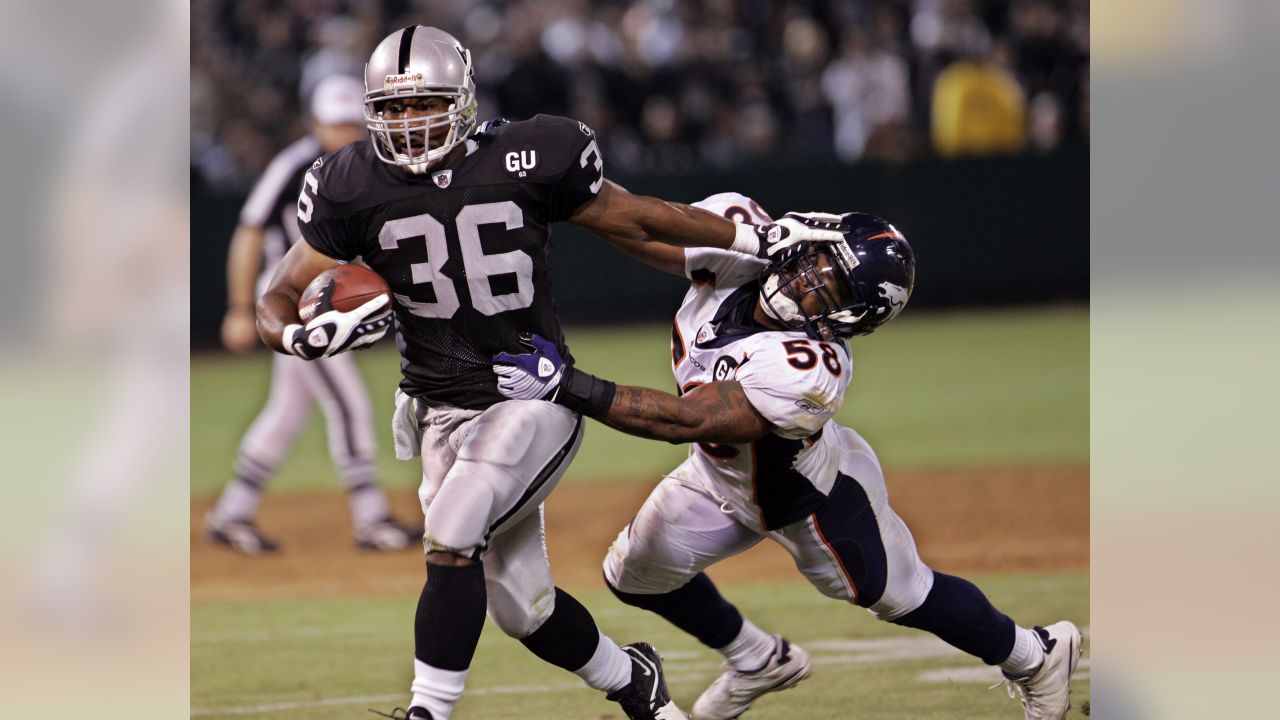 Baltimore Colt Ray May intercepts pass intended for Oakland Raider Raymond  Chester