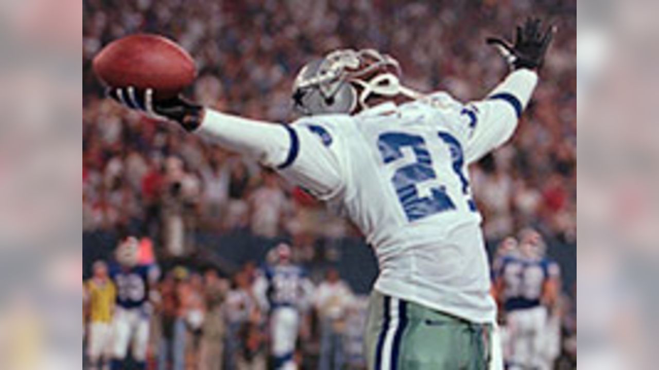 FILE - San Francisco 49ers quarterback Steve Young upends Dallas Cowboys  cornerback Deion Sanders after Sanders intercepted Young in the first  quarter of their Sunday, Nov 2, 1997, game in San Francisco.