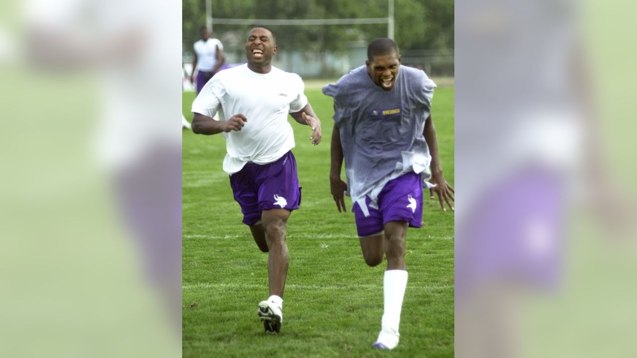 Minnesota Vikings wide receivers Cris Carter, left, and Randy Moss enjoy a  laugh as they wind down their first day of training camp with wind sprints  Monday, July 30, 2001, in Mankato