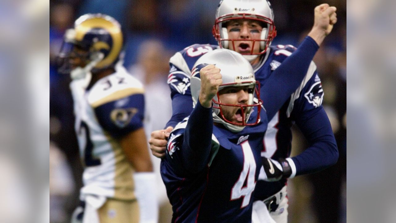 New England Patriots' cornerback Terrell Buckley (27) scoops up a St. Louis  Rams fumble in front of Patriots' Lawyer Milloy (36) and Tebucky Jones (34)  in Super Bowl XXXVI Sunday, Feb. 3