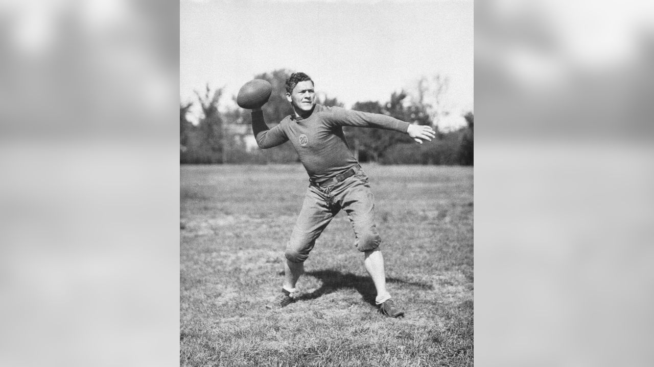 Earl Curly Lambeau, seated, coach of the Green Bay Packers for