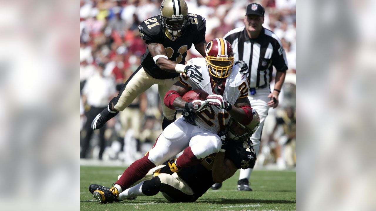 Clinton Portis is tackled by Nick Ferguson in the third quarter of