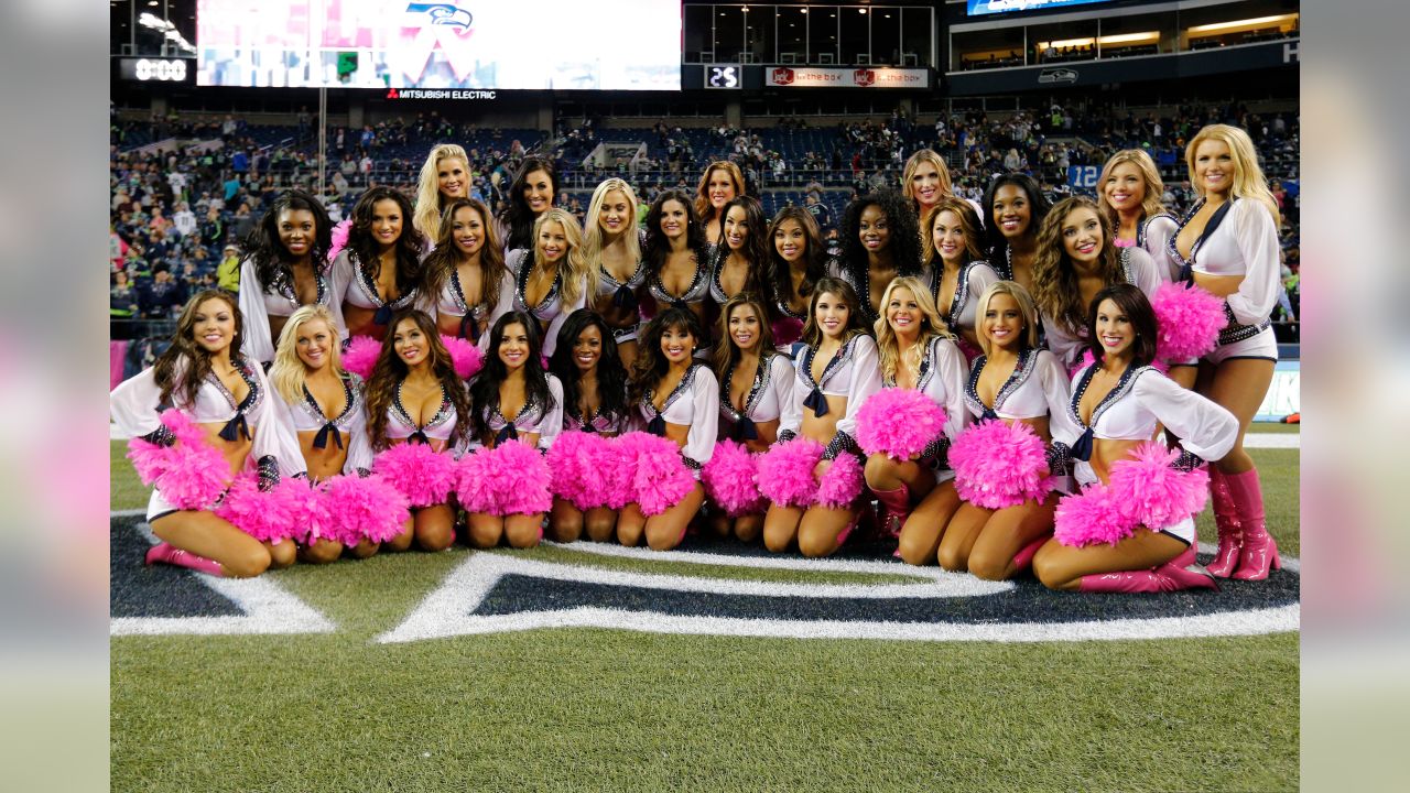 A fan wears a Dallas Cowboy cheerleader costume and pink gloves in