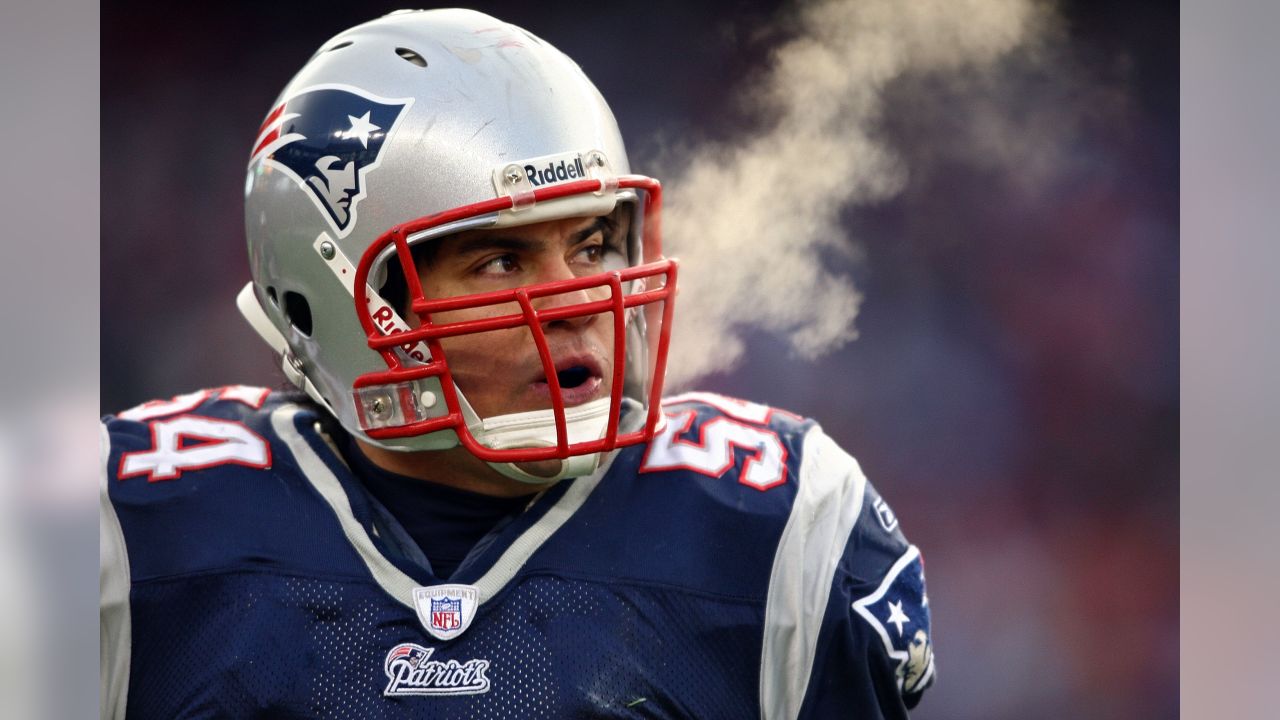 New England Patriots linebacker Junior Seau (55) hoists the AFC Championship  Lamar Hunt trophy after the team defeated the San Diego Chargers 21-12 in  the AFC Championship game at Gillette Stadium in