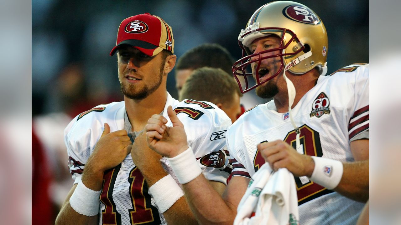 Utah quarterback Alex Smith, left, holds up a San Francisco 49ers