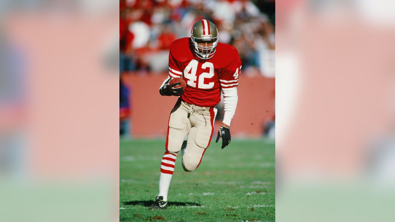 San Francisco 49ers cornerback Ronnie Lott (42) slams into Miami