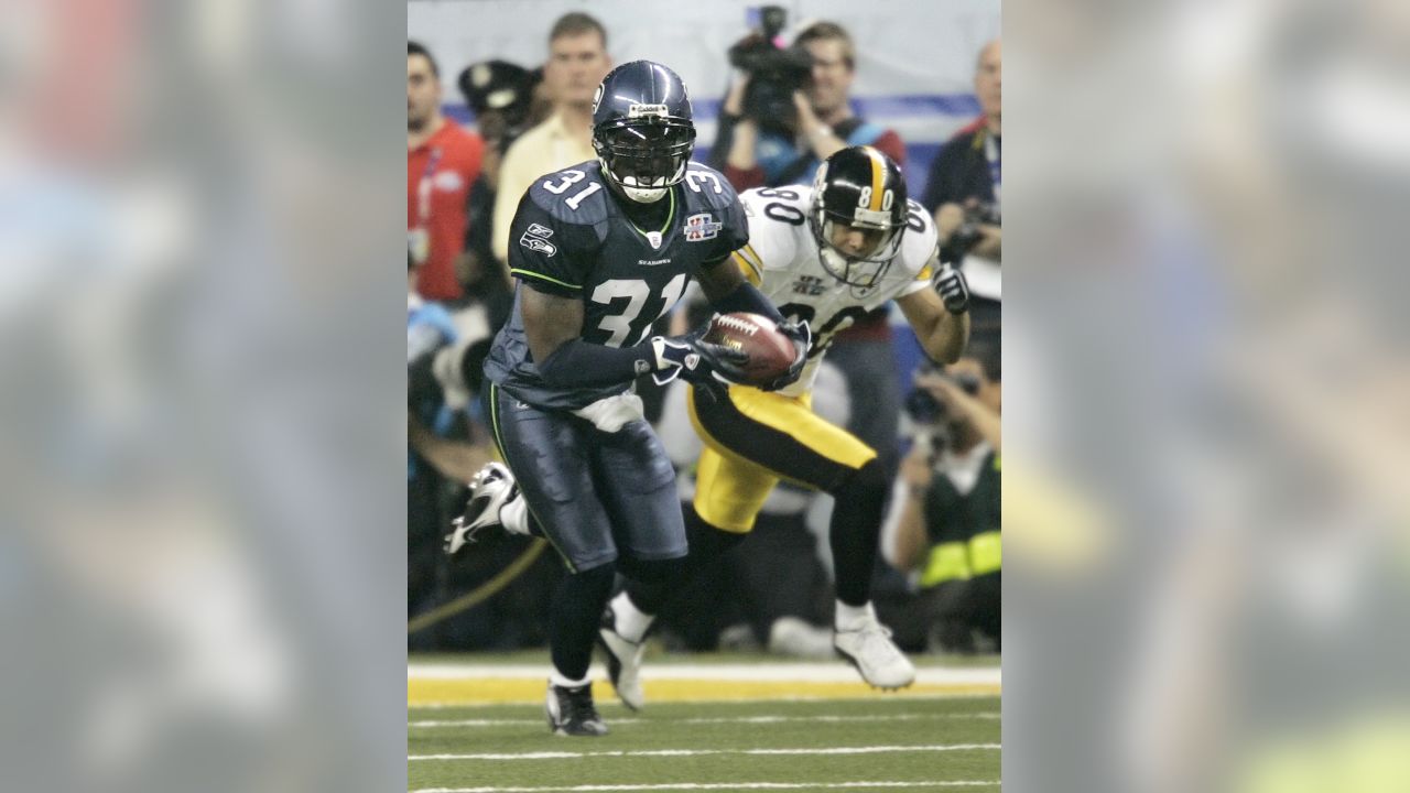 Pittsburgh Steelers running back Jerome Bettis (36) runs for a short gain  while being pursued by Seattle Seahawks linebacker Lofa Tatupu in the  second quarter of the Super Bowl XL football game