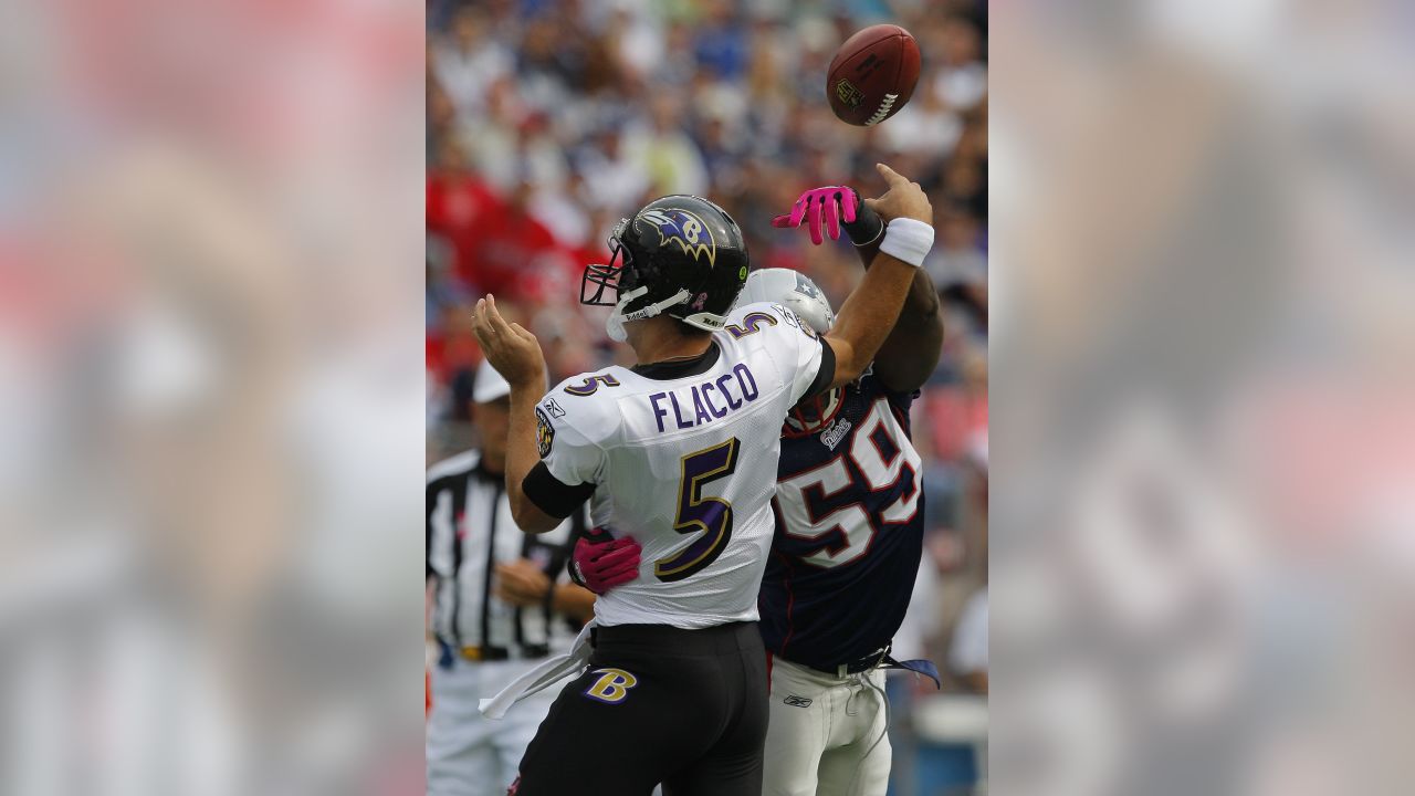 Randy Moss of the New England Patriots adjust his pink gloves