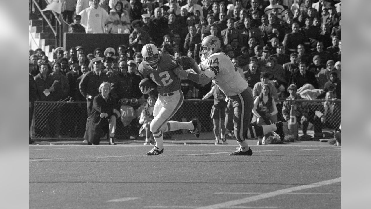 John Brodie (12), San Francisco 49ers quarterback, wasn't quite fast enough  to get away from Dallas Cowboy tackle Bob Lilly (74), who came charging  through the line to drop Brodie for a