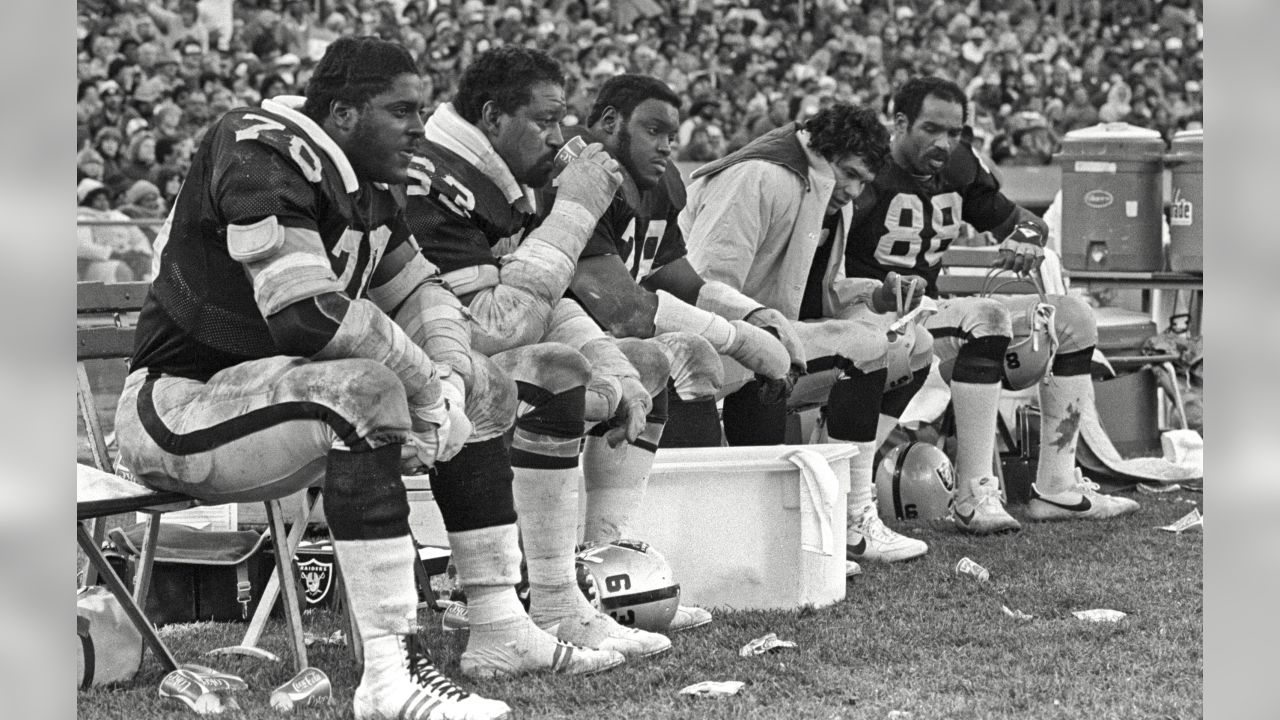 Oakland Raiders quarterback Jim Plunkett takes a snap during the playoff  game between the Cleveland Browns and the Oakland Raiders at Cleveland  Stadium on Jan. 4, 1981. Gene Upshaw is number 63