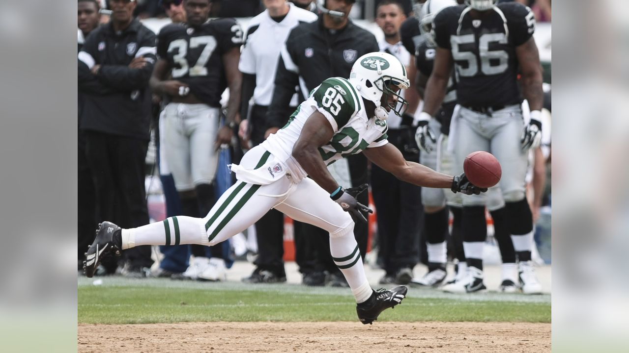 Sep 25, 2011; Oakland, CA, USA; New York Jets wide receiver Derrick Mason ( 85) is tackled by Oakland Raiders defensive back Joe Porter (28) during the  second quarter at O.co Coliseum. Oakland