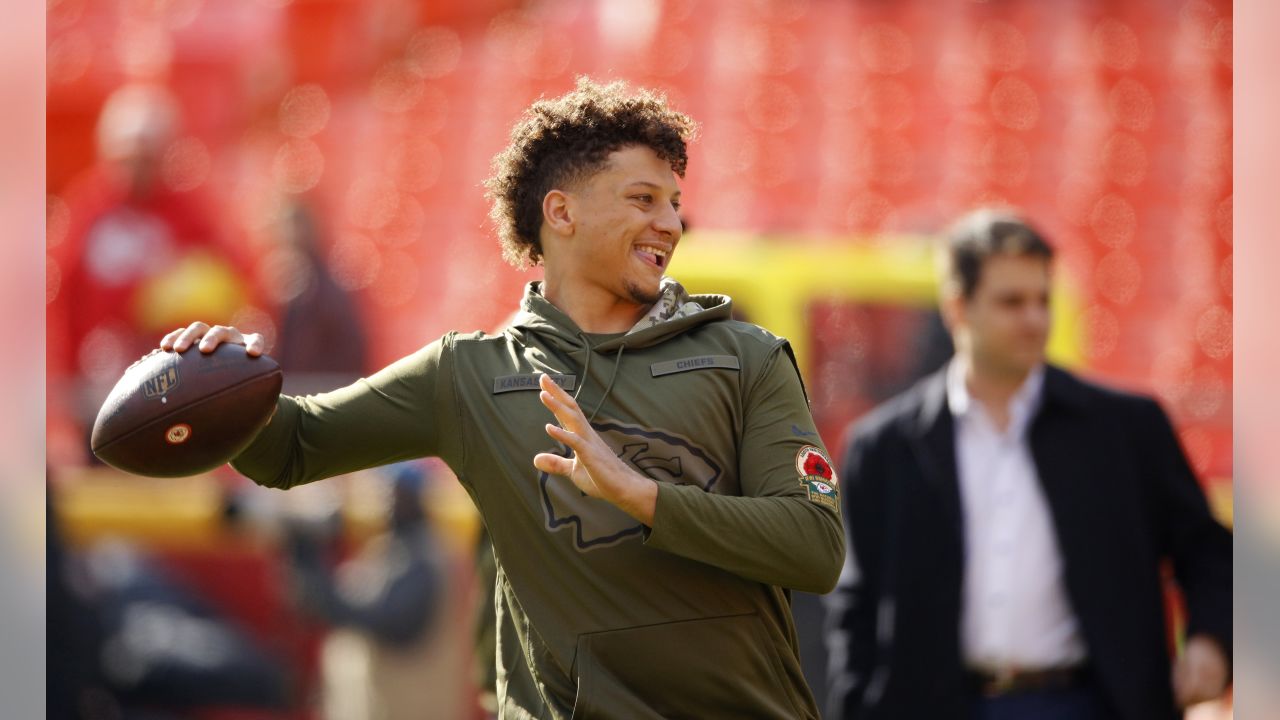 Kansas City Chiefs quarterback Patrick Mahomes (15) throws a pass as Arizona  Cardinals defensive tackle Corey Peters (98) closes in, during the first  half of an NFL football game in Kansas City