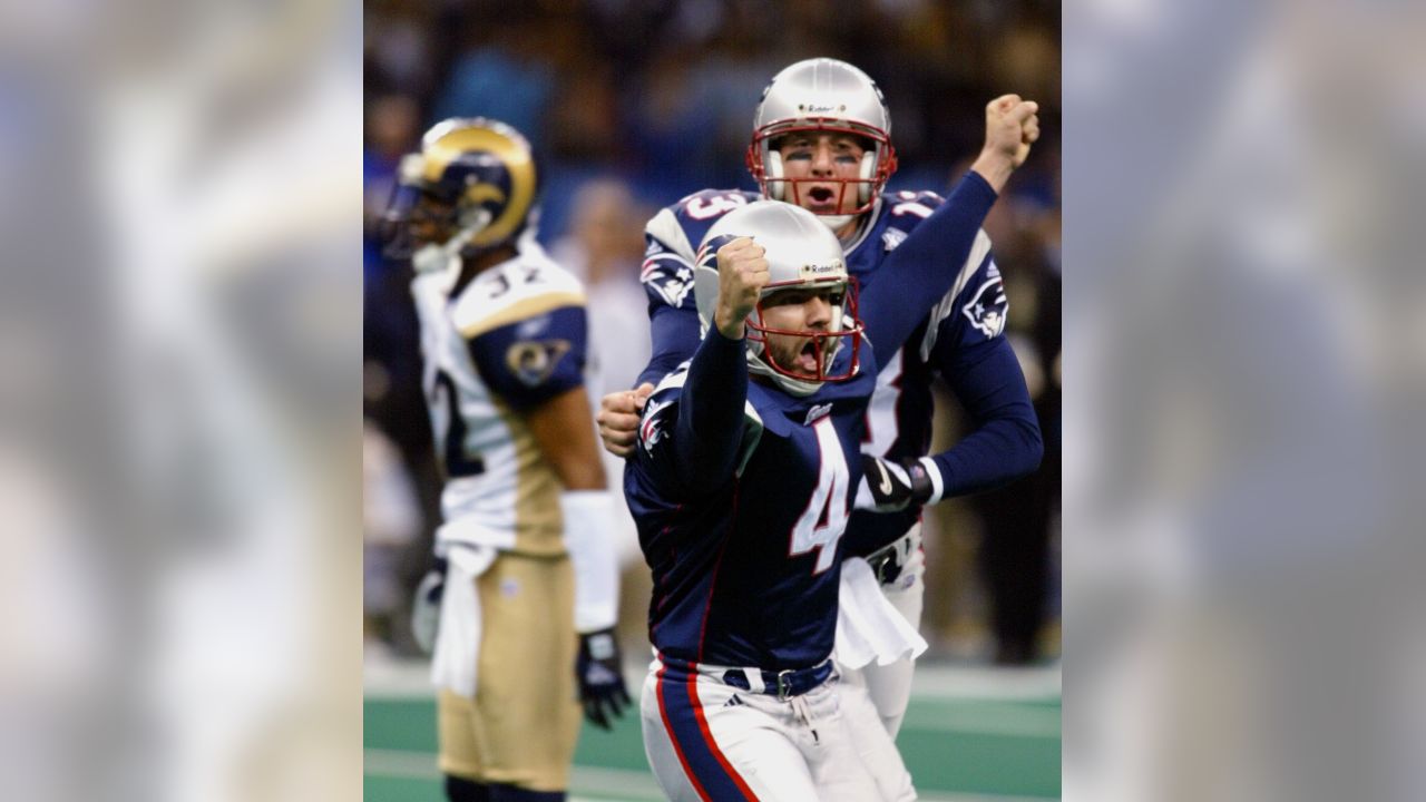 New England Patriots' cornerback Terrell Buckley (27) scoops up a St. Louis  Rams fumble in front of Patriots' Lawyer Milloy (36) and Tebucky Jones (34)  in Super Bowl XXXVI Sunday, Feb. 3