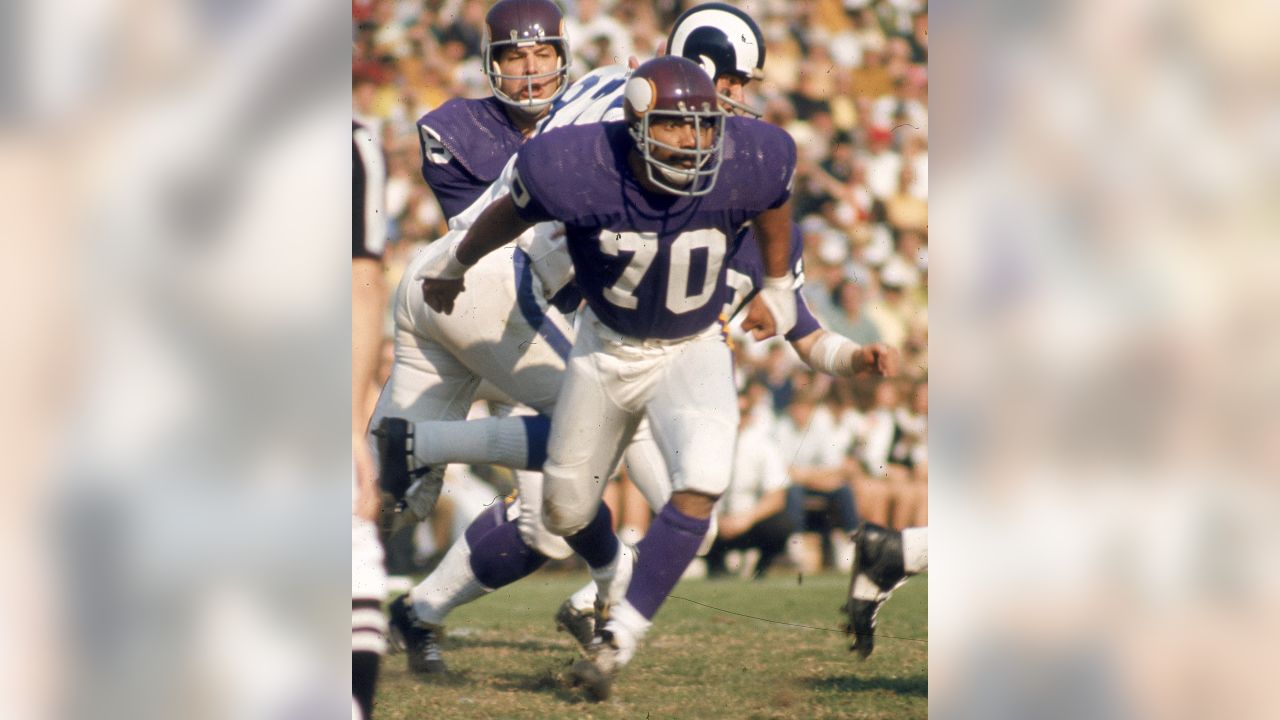 FILE ** Minnesota Vikings' Jim Marshall (70) clutches the game ball as he  is carried off the field by teammates Doug Southerland, left, and Scott  Studwell after the Vikings beat the