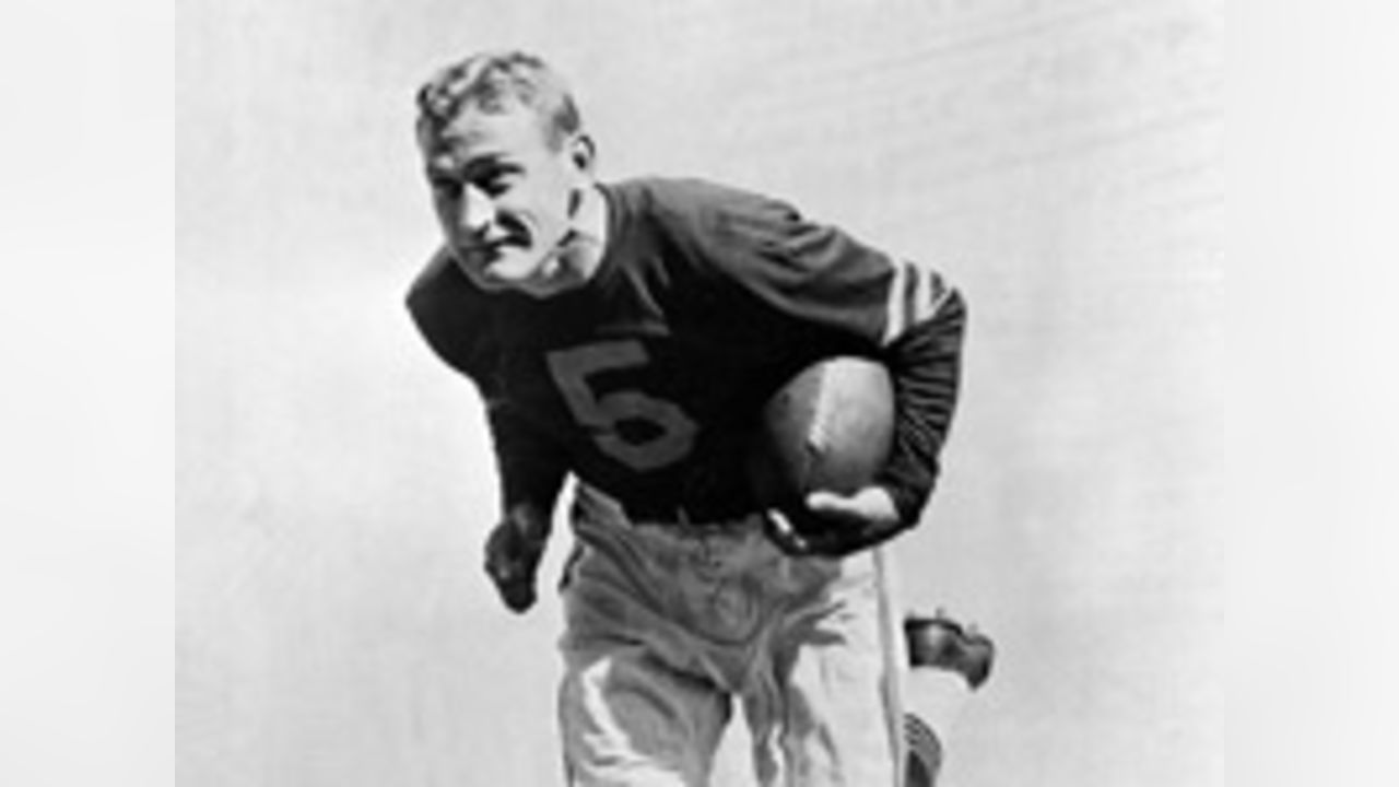 Sid Luckman, left, Chicago Bears' quarterback, gets a hug and a kiss from  teammate George McAfee, center, as Ray McLean, right, watches in the  dressing room following Chicago's defeat of the New