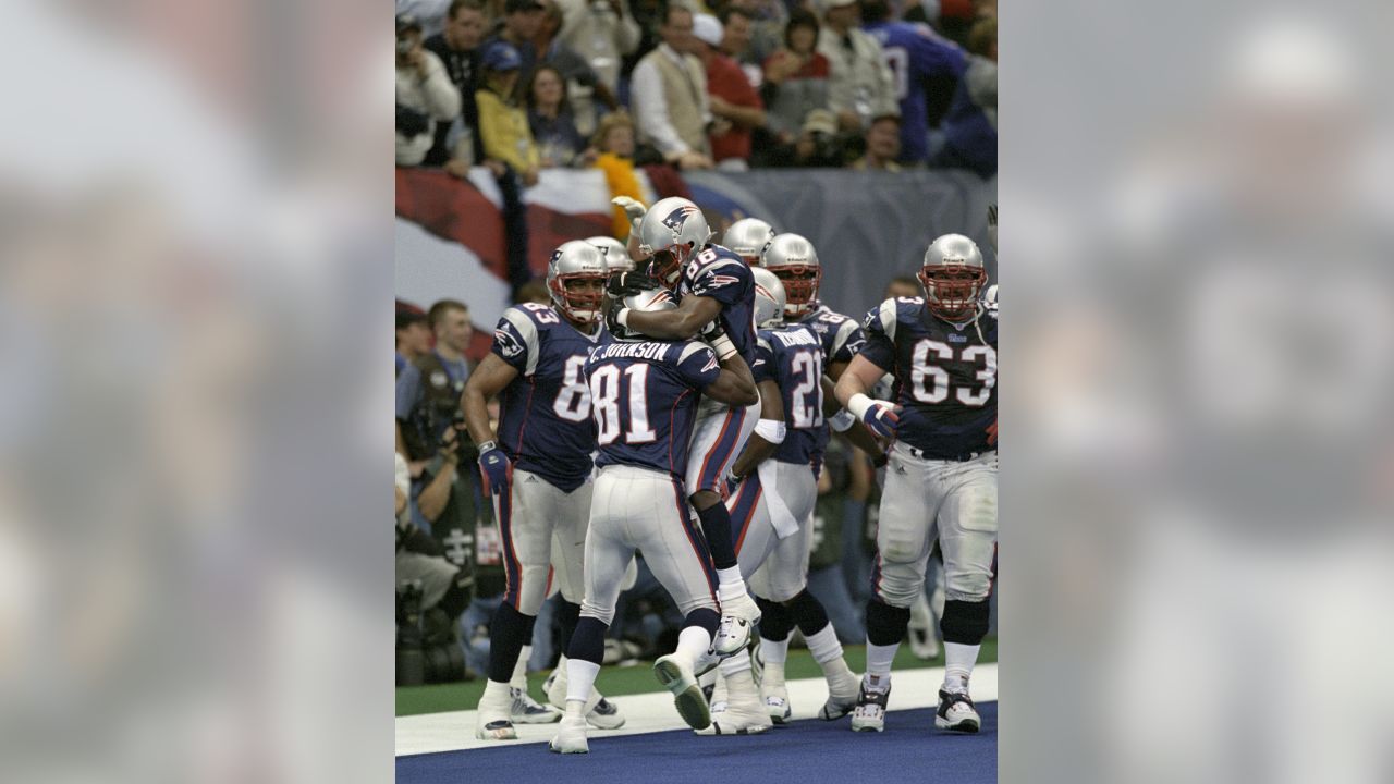 New England Patriots' cornerback Terrell Buckley (27) scoops up a St. Louis  Rams fumble in front of Patriots' Lawyer Milloy (36) and Tebucky Jones (34)  in Super Bowl XXXVI Sunday, Feb. 3