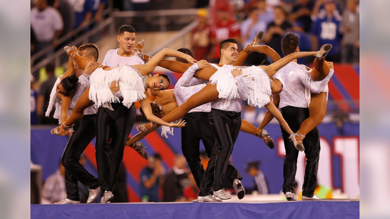 Dancers hold flags of nations of hispanic heritage honoring Hispanic  Heritage Month prior to a NFL football game between the Miami Dolphins and  Dallas Cowboys in Arlington, Texas, Sunday, Sept. 22, 2019. (