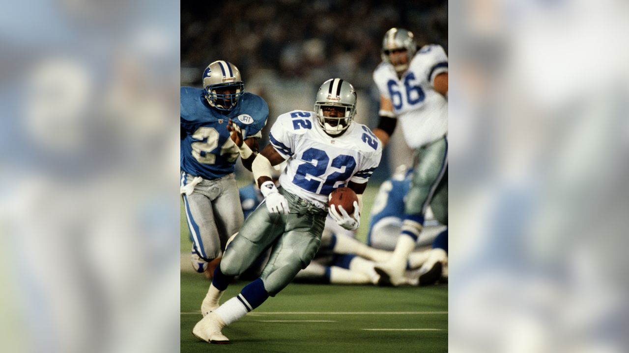 Former Dallas Cowboys head coach Jimmy Johnson, left, hands Florida running  back Emmitt Smith his No. 22 jersey as the Cowboys 1990 No. 1 draft pick is  introduced at the Cowboys training