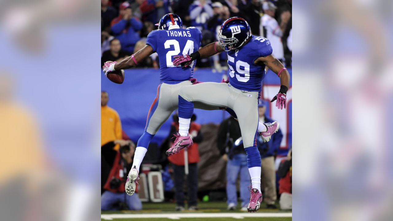 New York Giants linebacker Michael Boley (59) celebrates with safety Kenny  Phillips (21) after Phillips broke up a passing play during first half NFL  action between the New York Giants and the