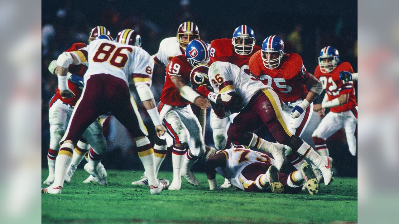 Washington Redskins cornerback Barry Wilburn (45) tries to stop Denver  Broncos Ricky Nattiel (84) from getting into the endzone after Nattiel  hauled in pass from quarterback John Elway during first quarter of