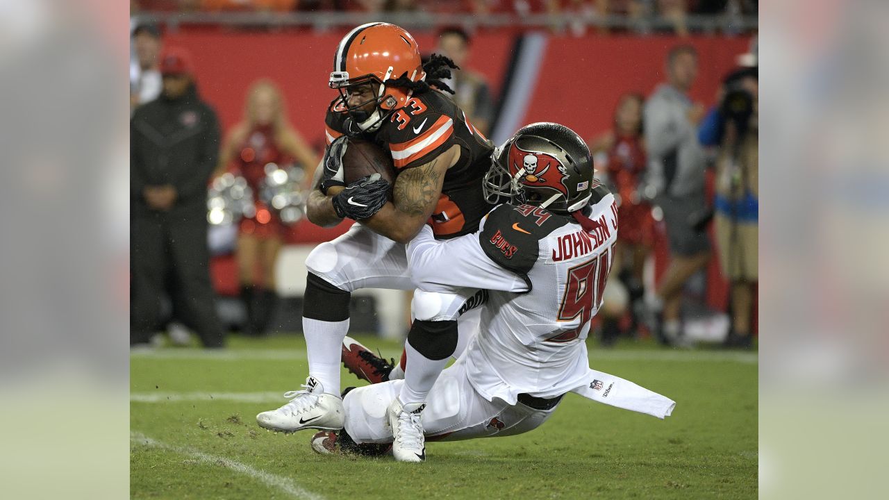 Cleveland Browns running back Isaiah Crowell (34) eludes a tackle by Tampa  Bay Buccaneers strong safety Keith Tandy (37) during the first quarter of  an NFL preseason football game Saturday, Aug. 26