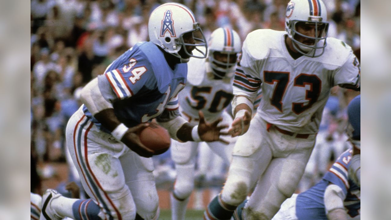 Houston Oilers running back Earl Campbell (34), tries to run