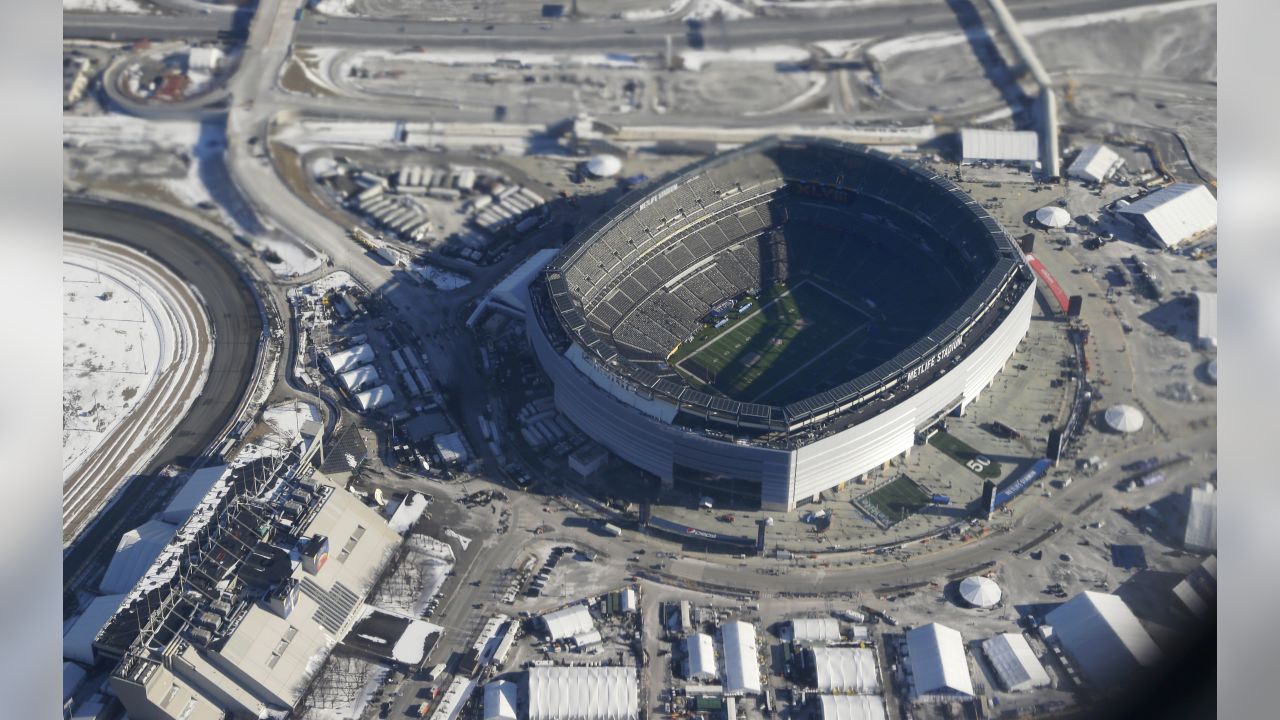 A painted Seattle Seahawks fans looks on while on the phone at the Super  Bowl XLVIII at MetLife Stadium in East Rutherford, New Jersey on February  2, 2014. MetLife Stadium hosts the