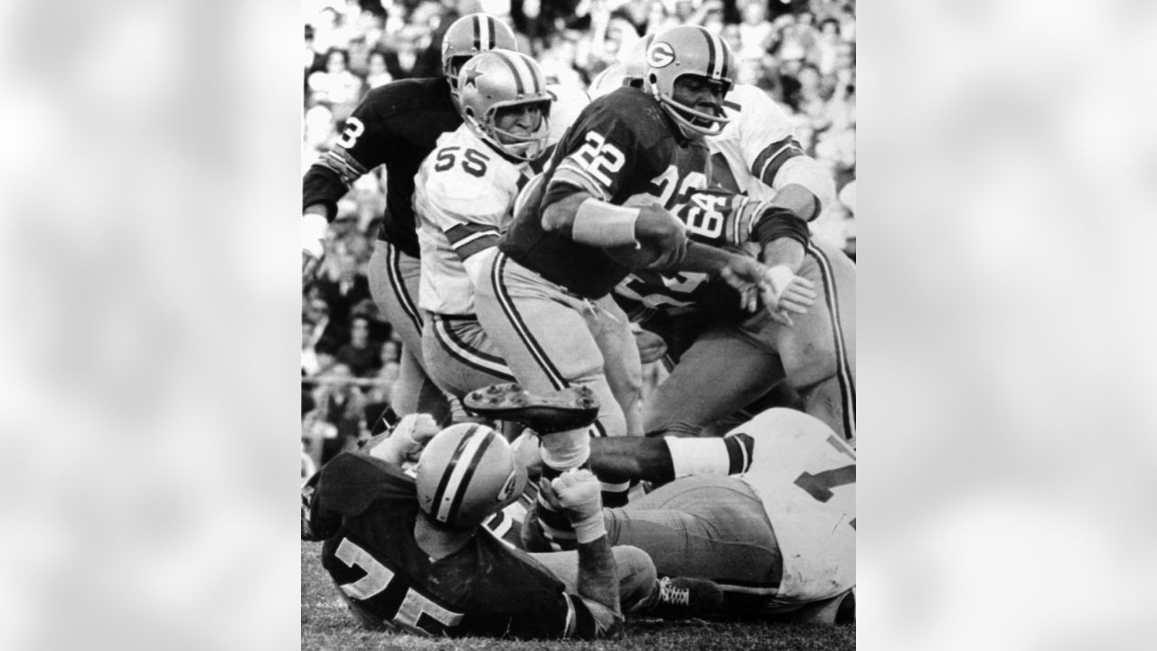 FILE ** Dallas Cowboys quarterback Don Meredith (17), white jersey at  center, falls back on top of a Green Bay Packers player as players chase a  fumble during the NFL Championship