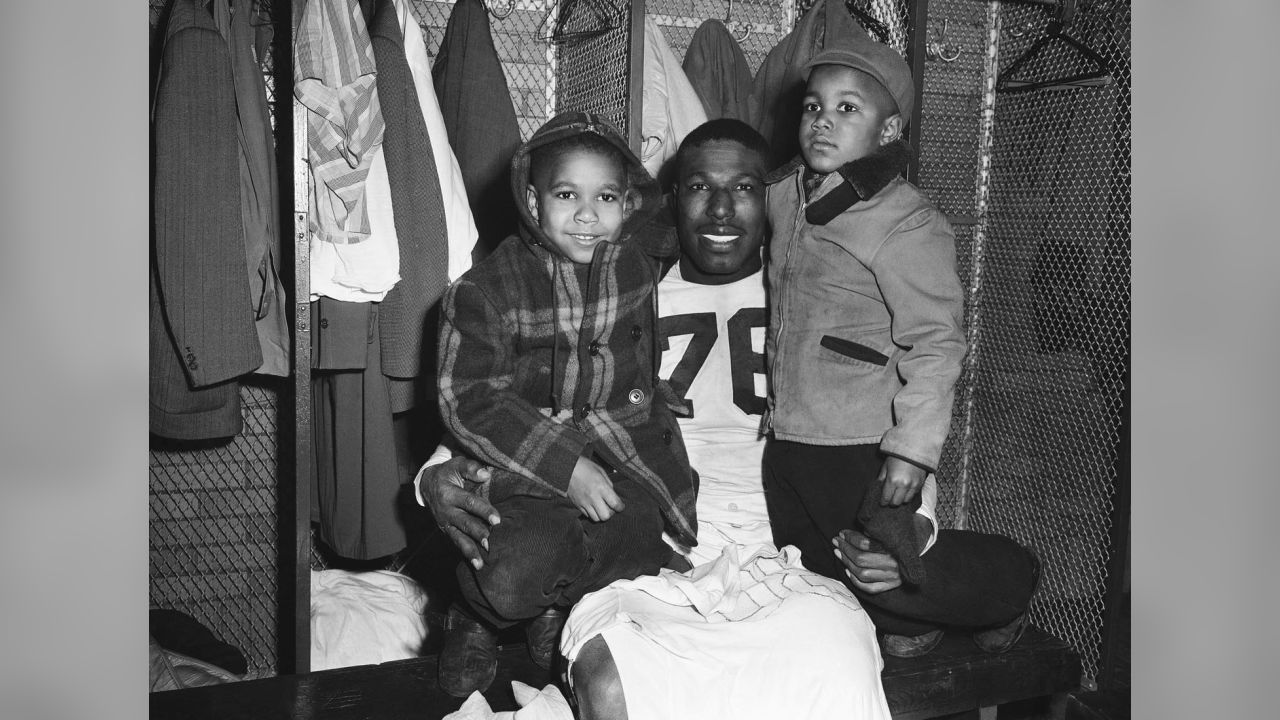 FILE - In this Dec. 19, 1948, file photo, Cleveland Browns fullback Marion  Motley, right, stands with coach Paul Brown after a football game against  Buffalo in Cleveland. Brown never saw color