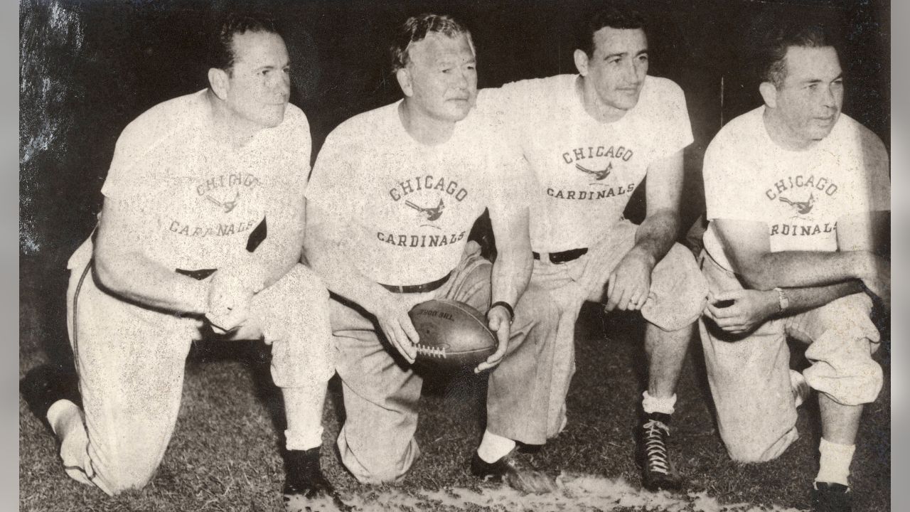 Earl Curly Lambeau, seated, coach of the Green Bay Packers for