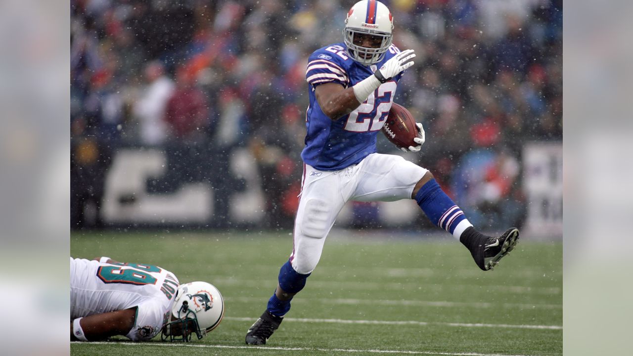 Detroit Lions running back Kevin Jones, (34) breaks away from Buffalo Bills  linebacker Angelo Crowell for a 7-yard touchdown in the first quarter of  their NFL football game in Detroit, Sunday, Oct.