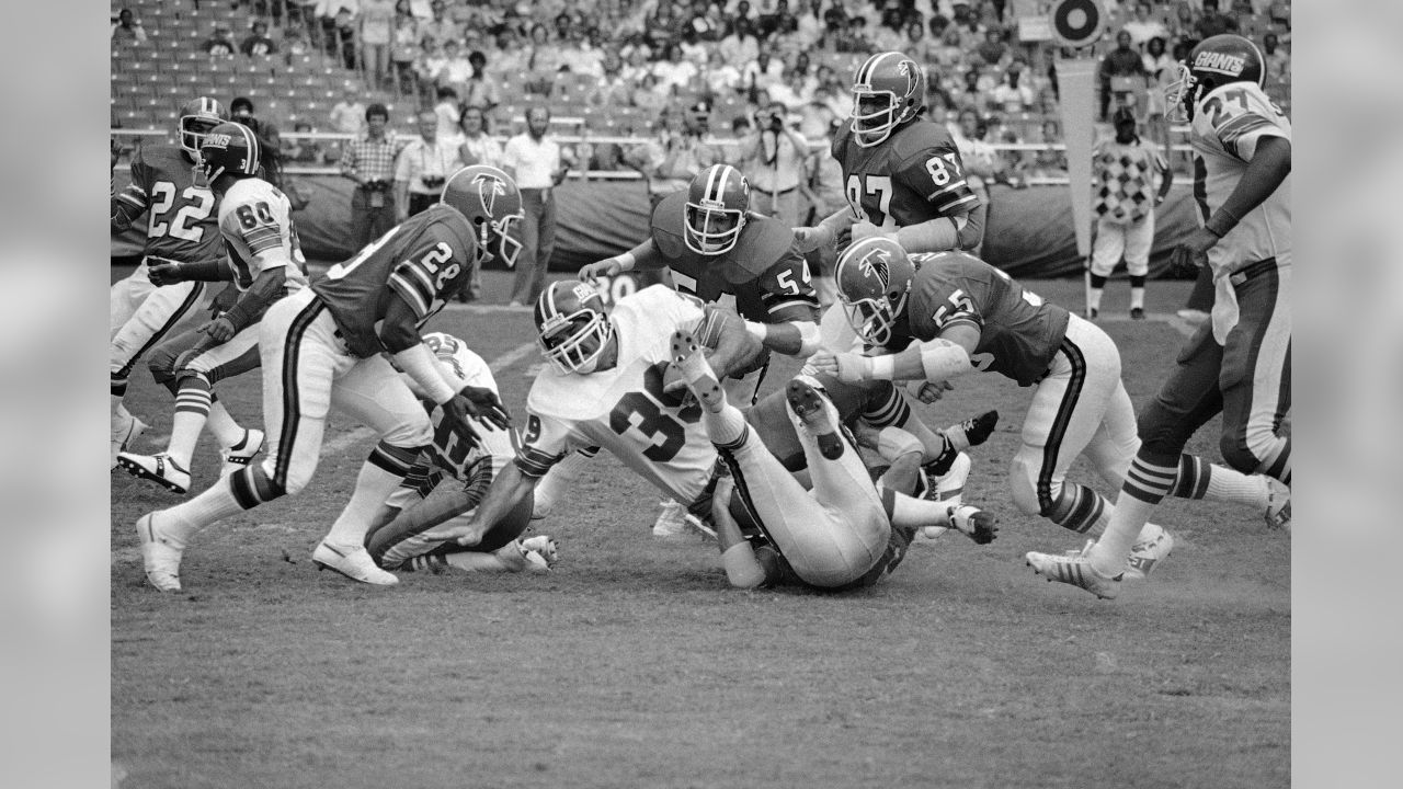 New York Giants running back Brandon Jacobs (27) is brought down by Atlanta  Falcons linebacker Keith Brooking (56) in the second quarter of a football  game Monday, Oct. 15, 2007 in Atlanta. (