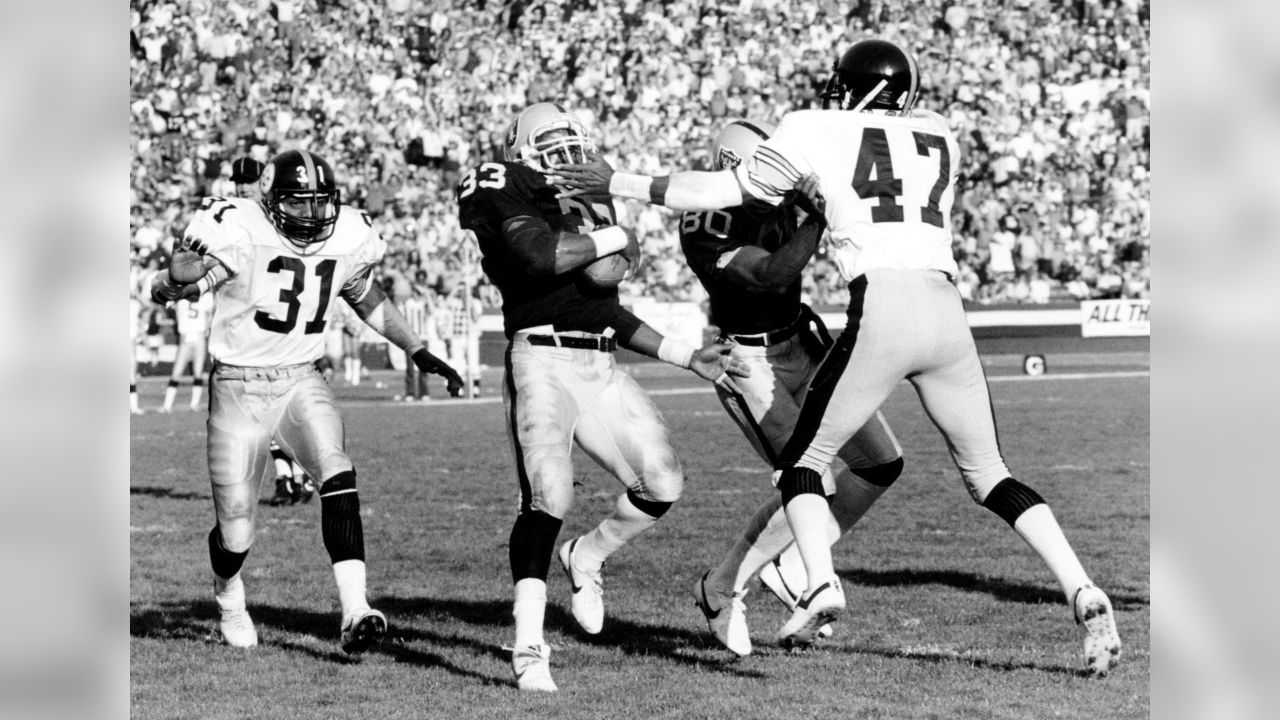 Pittsburgh Steelers' Mel Blount tries to keep Cincinnati Bengals' Don Bass  from seeing the action as Blount grabs the 22 yard touchdown pass  regardless of Blount's attempts, Sept. 21, 1980. (AP Photo