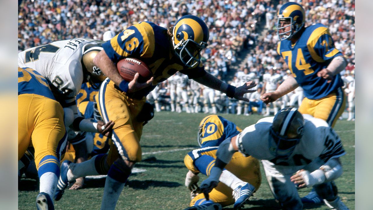 Los Angeles Rams quarterback Ron Jaworski steps into the end zone after a  short run as St. Louis Cardinals' Greg Hartle tries for the tackle during  the first quarter of their game