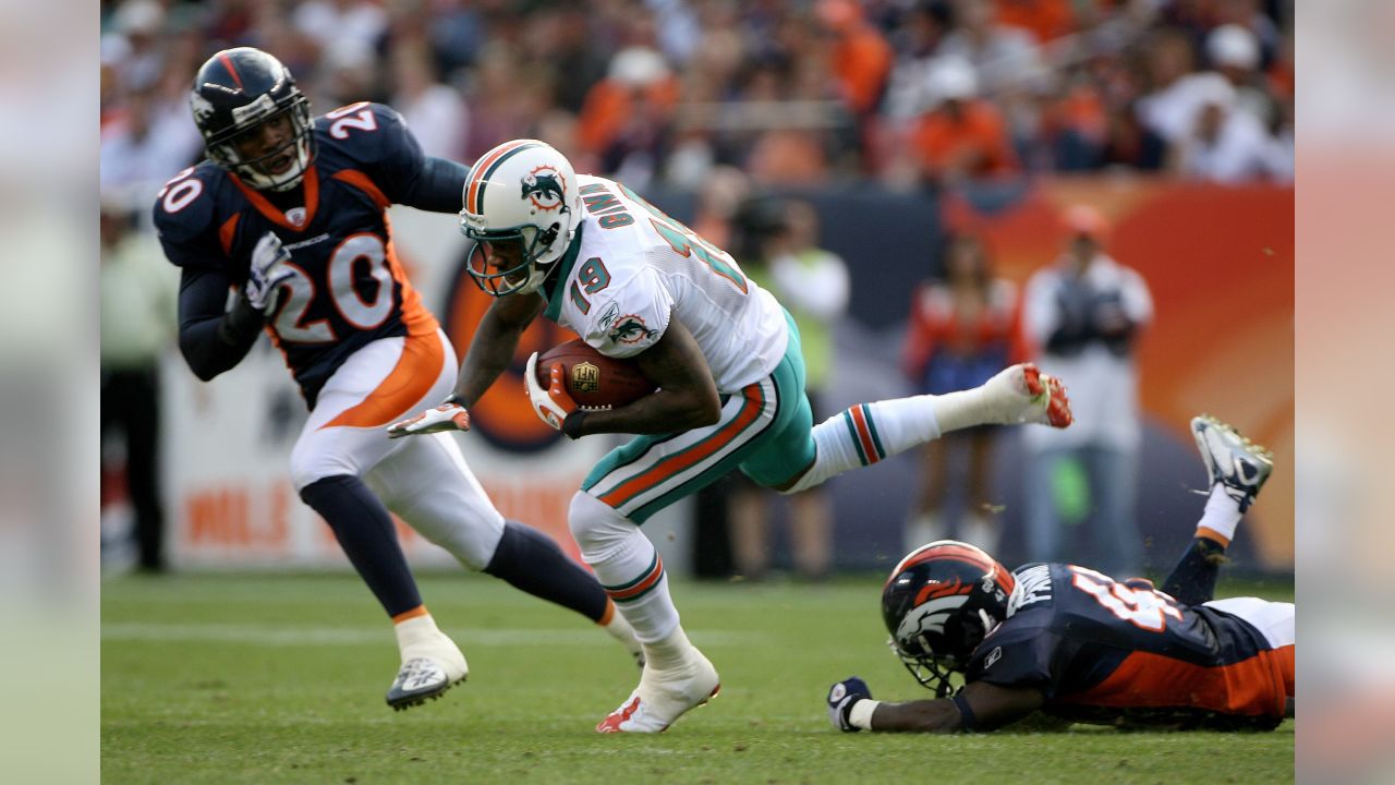 Miami Dolphins running back Ronnie Brown is brought down by Denver Broncos  cornerback Dre Bly in the fourth quarter in Denver, Colorado, Sunday,  November 2, 2008. The Dolphins defeated the Broncos 26-17. (