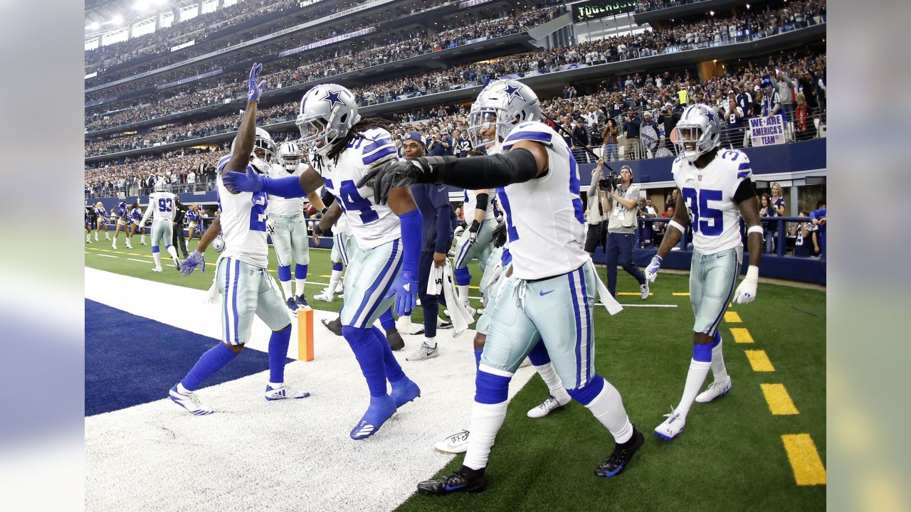 Dallas Cowboys' DeMarcus Lawrence (90) and Antwaun Woods, being lifted  celebrate a stop against the Tampa Bay Buccaneers as Jaylon Smith (54) and  Leighton Vander Esch (55) look on in the second