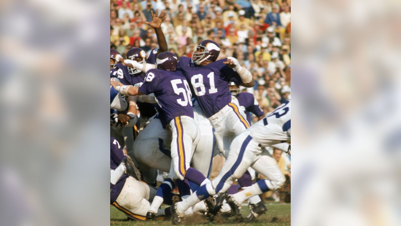 FILE ** Minnesota Vikings' Jim Marshall (70) clutches the game ball as he  is carried off the field by teammates Doug Southerland, left, and Scott  Studwell after the Vikings beat the