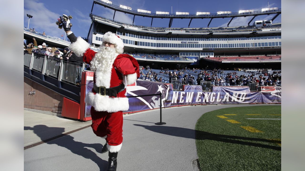 Jake Denooy of Fort Collins, Colo., places a Denver Broncos flag to top off  a Christmas tree while he tailgates before the Oakland Raiders face the  Broncos in the first quarter of